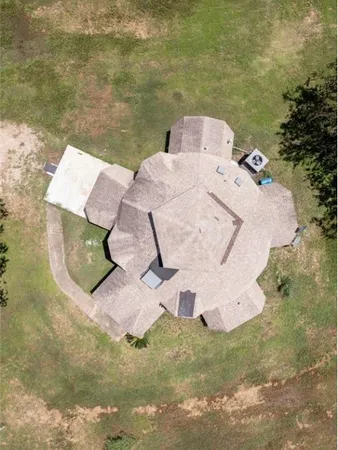 an aerial view of a house with outdoor space