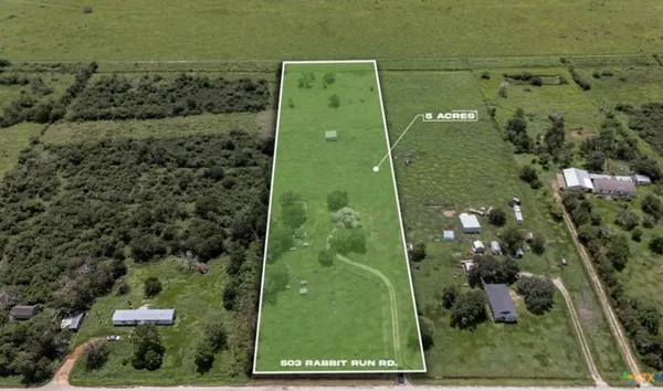 an aerial view of a residential houses with outdoor space