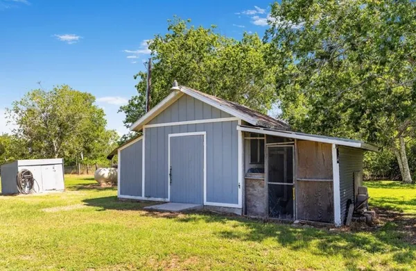 a view of an house with backyard space and wooden fence