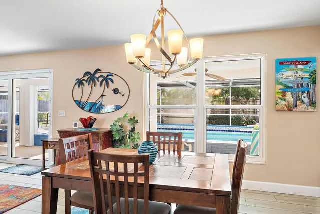 a dining room with furniture a rug and a large window