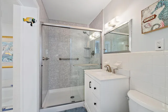 a bathroom with a sink mirror and shower