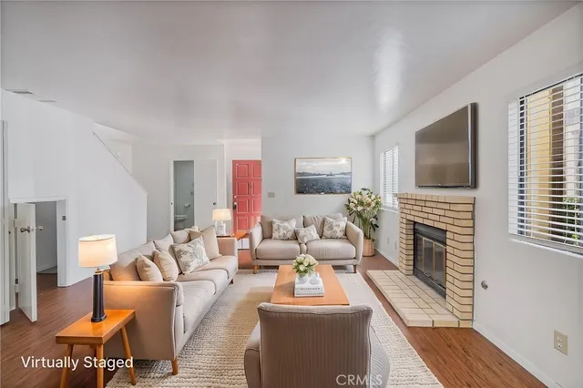 a living room with fireplace furniture and a flat screen tv