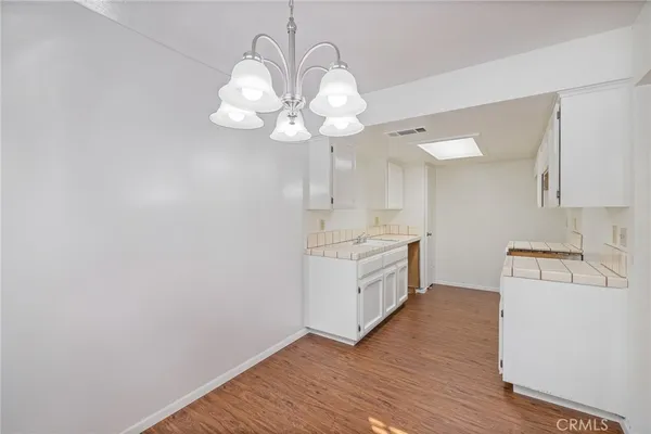 a kitchen with a sink cabinets and wooden floor