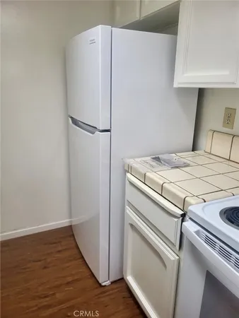 a white refrigerator freezer sitting inside of a kitchen