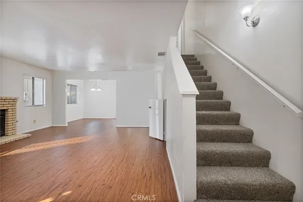 a view of entryway and hall with wooden floor