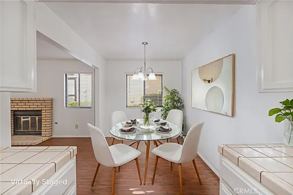 a dining room with furniture a chandelier and wooden floor