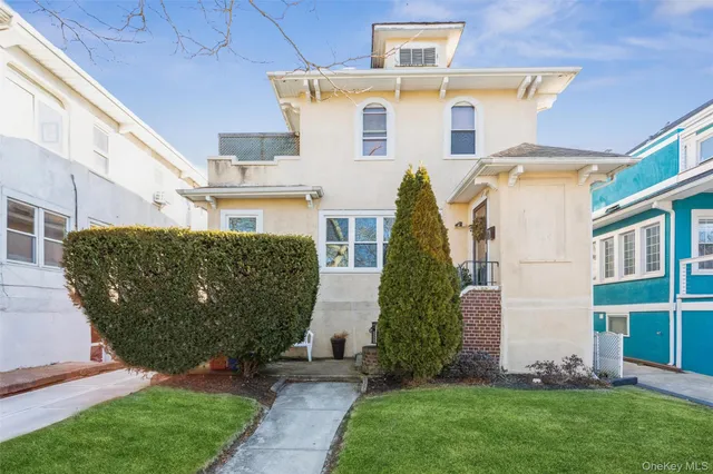 a front view of a house with a garden