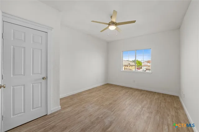 a view of a hallway view with wooden floor and staircase