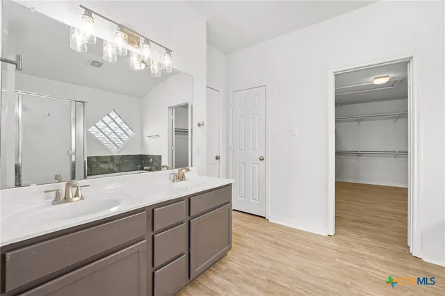 a bathroom with a bathtub a window and a shower