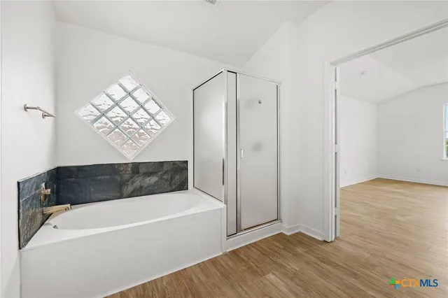 a view of a room with wooden floor