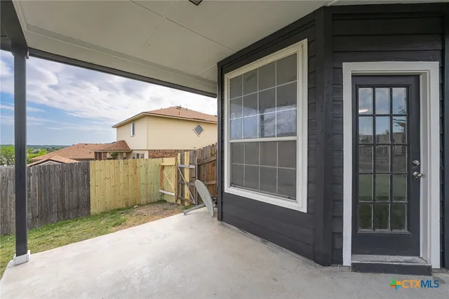 a view of a house with backyard from a porch