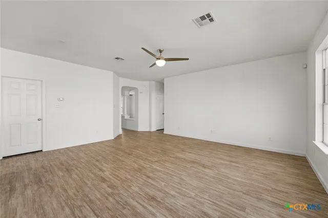 a view of a kitchen with a sink and a refrigerator