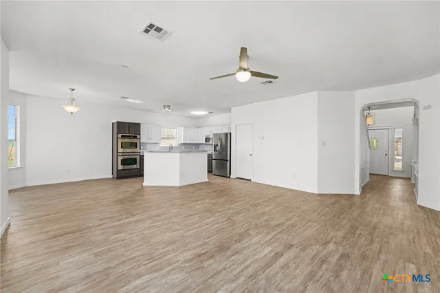 a large kitchen with granite countertop stainless steel appliances and a counter space