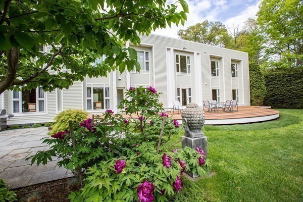 474 Glen Road Weston, MA 02493 - Photo 26 of 30 a view of a house with patio and a garden