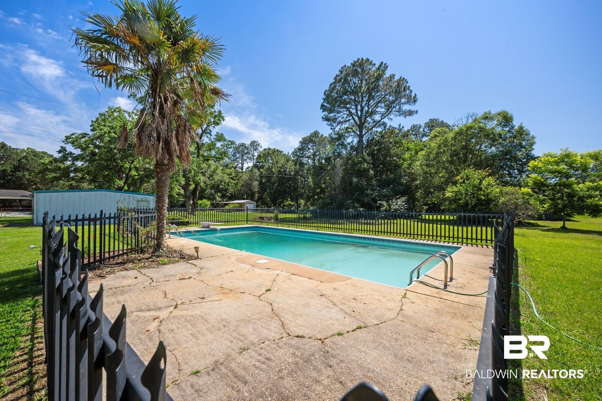 950 Walter Smith Road Mobile, AL 36695 - Photo 31 of 51 View of pool with view of wooded area and a patio
