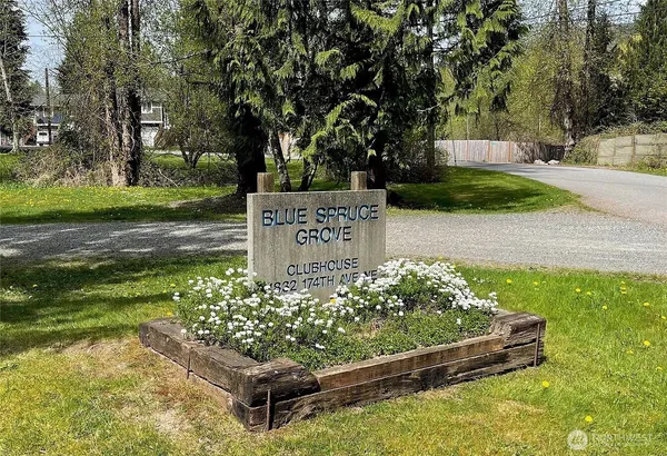 a wooden bench sitting in the middle of a park