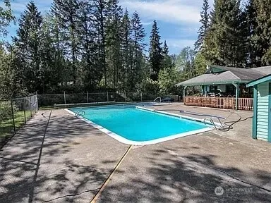 a view of a swimming pool with an outdoor space and seating area