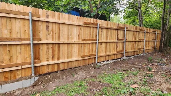 a view of a backyard with a fence