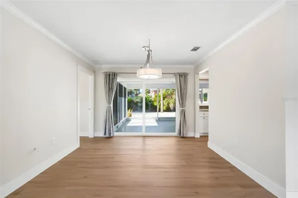 a view of a room with wooden floor