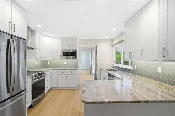 a view of a kitchen with wooden floor