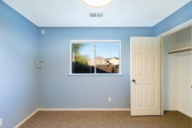 a view of a room with wooden floor and cabinet