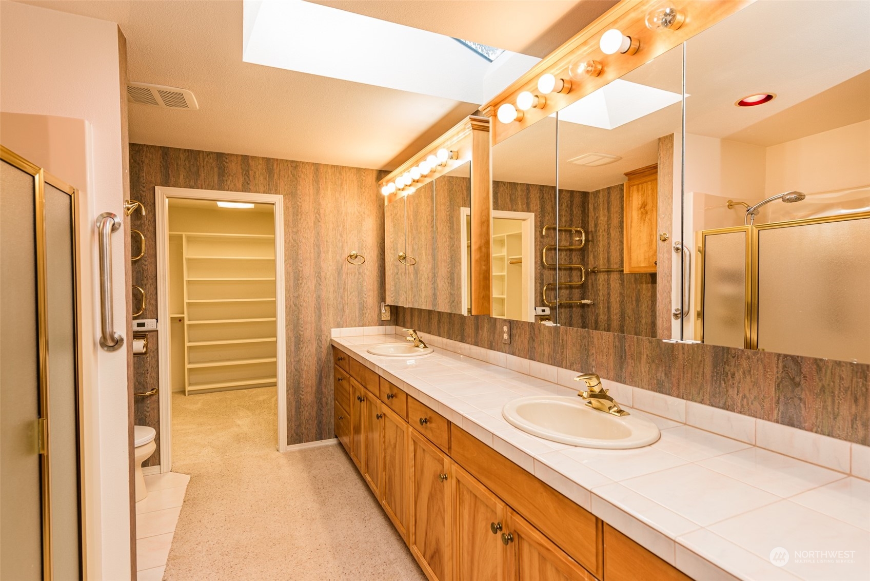 653 Brigadoon Boulevard Sequim, WA 98382 - Photo 20 of 40 a bathroom with a granite countertop sink and a mirror