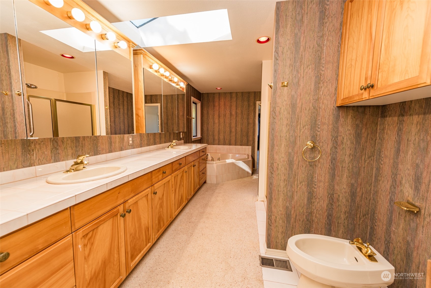 653 Brigadoon Boulevard Sequim, WA 98382 - Photo 21 of 40 a bathroom with a double vanity sink and a mirror
