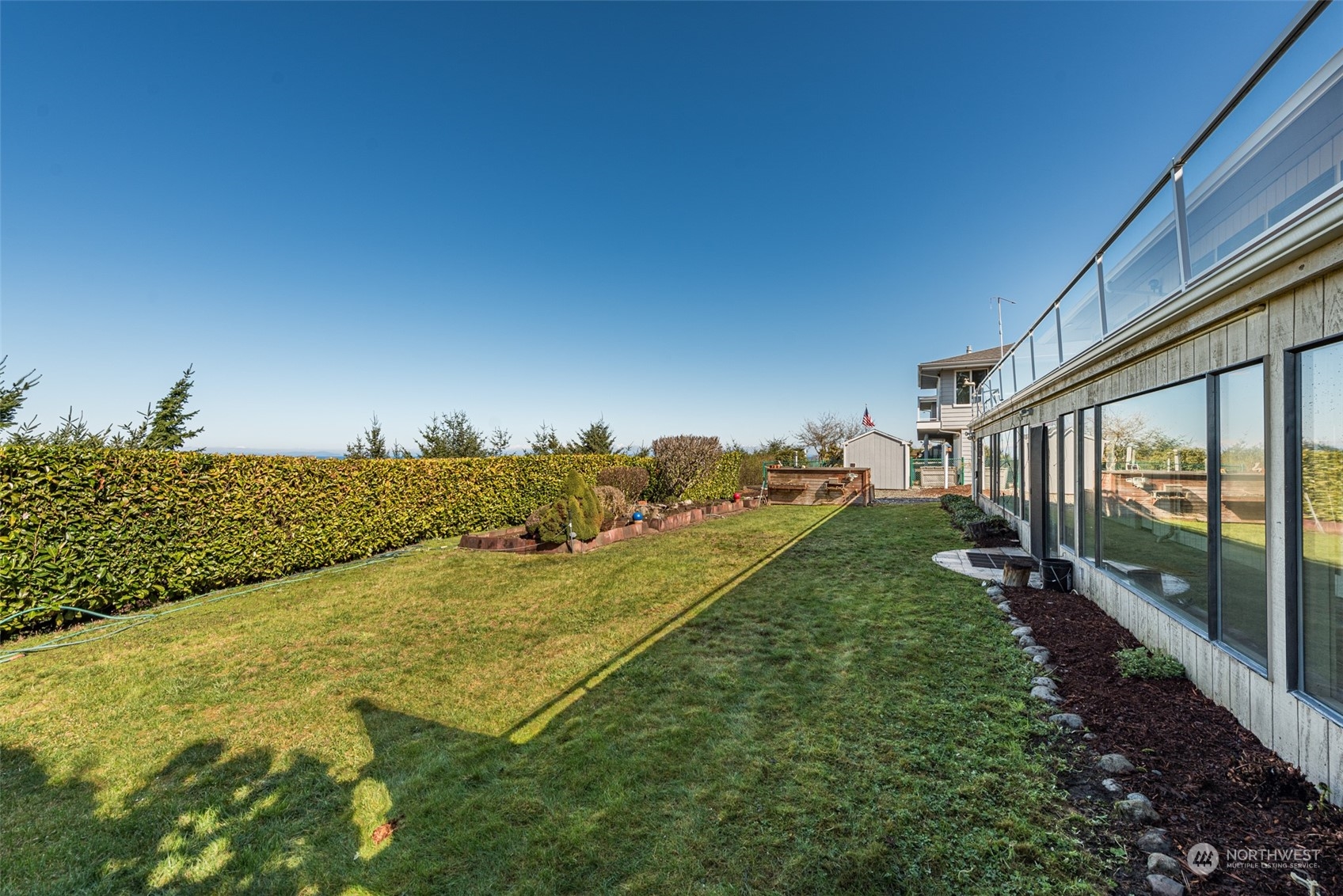 653 Brigadoon Boulevard Sequim, WA 98382 - Photo 31 of 40 a view of a big yard with potted plants