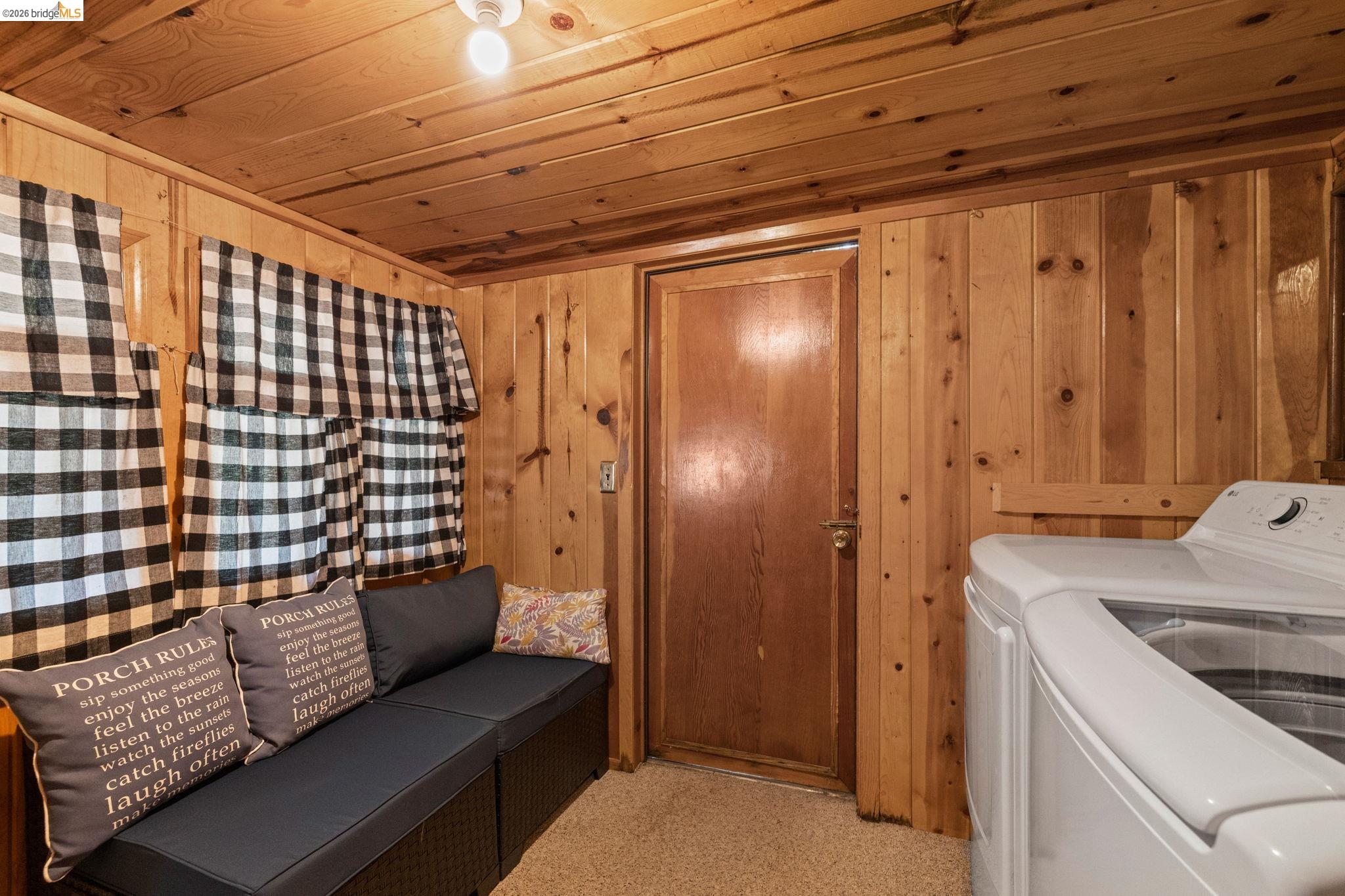 26175 Janice Way Long Barn, CA 95335 - Photo 10 of 23 Laundry area featuring wood ceiling, wood walls, washer and clothes dryer, and carpet flooring