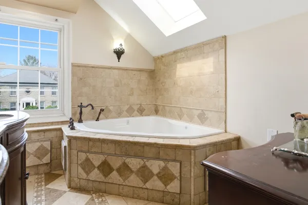 a bedroom with a bed window and a dresser