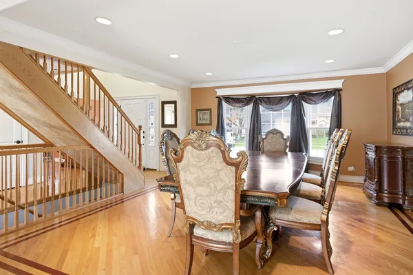 a view of a dining room with furniture a chandelier and wooden floor