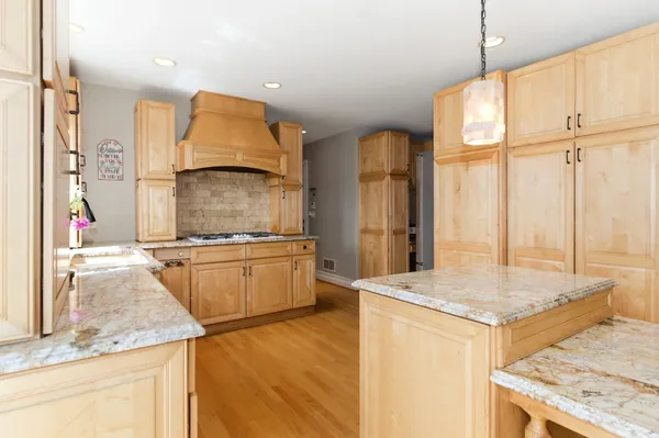 a kitchen with granite countertop a sink and a stove