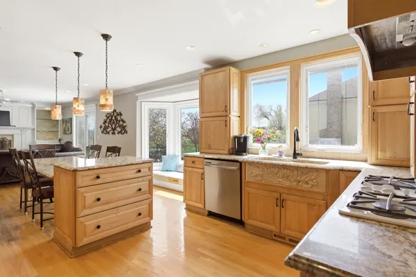 a view of a kitchen with a refrigerator and wooden floor