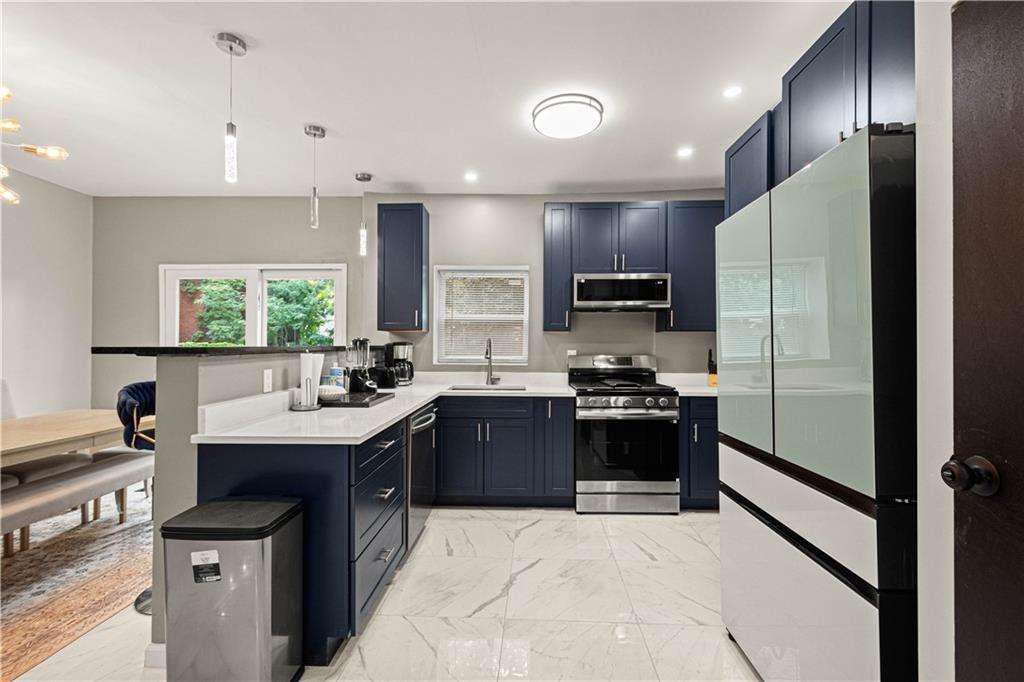 214 North Aiken Avenue Pittsburgh, PA 15206 - Photo 10 of 37 Samsung appliances and open sightlines to the dining area