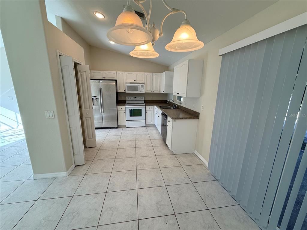 4185 Amari Road North Port, FL 34291 - Photo 6 of 14 a kitchen with stainless steel appliances a refrigerator and a sink