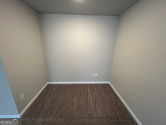 a view of room with wooden floor