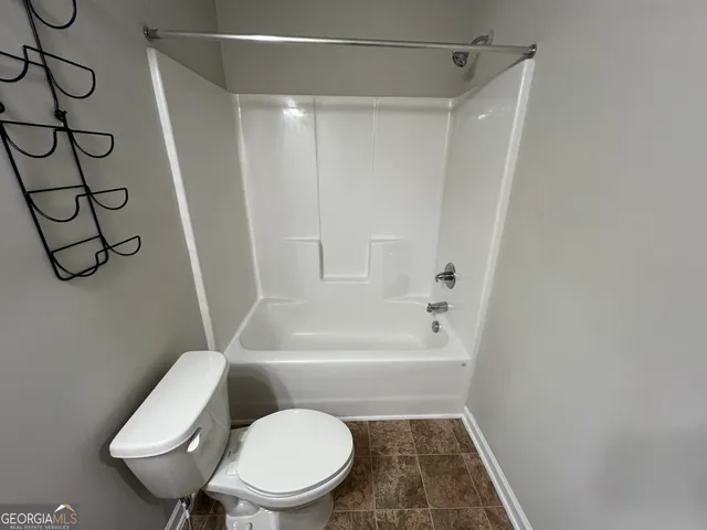 a bathroom with a tub and shower