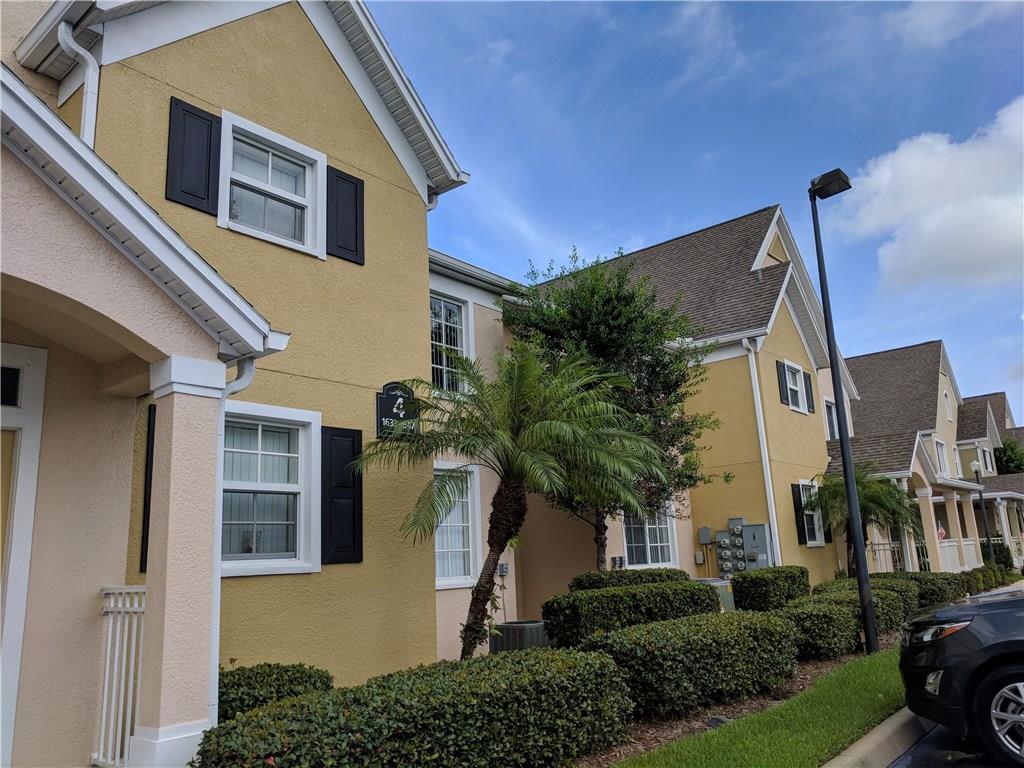 1645 Southeast Pomeroy Street, Unit 42 Stuart, FL 34997 - Photo 1 of 29 a front view of a house with a yard