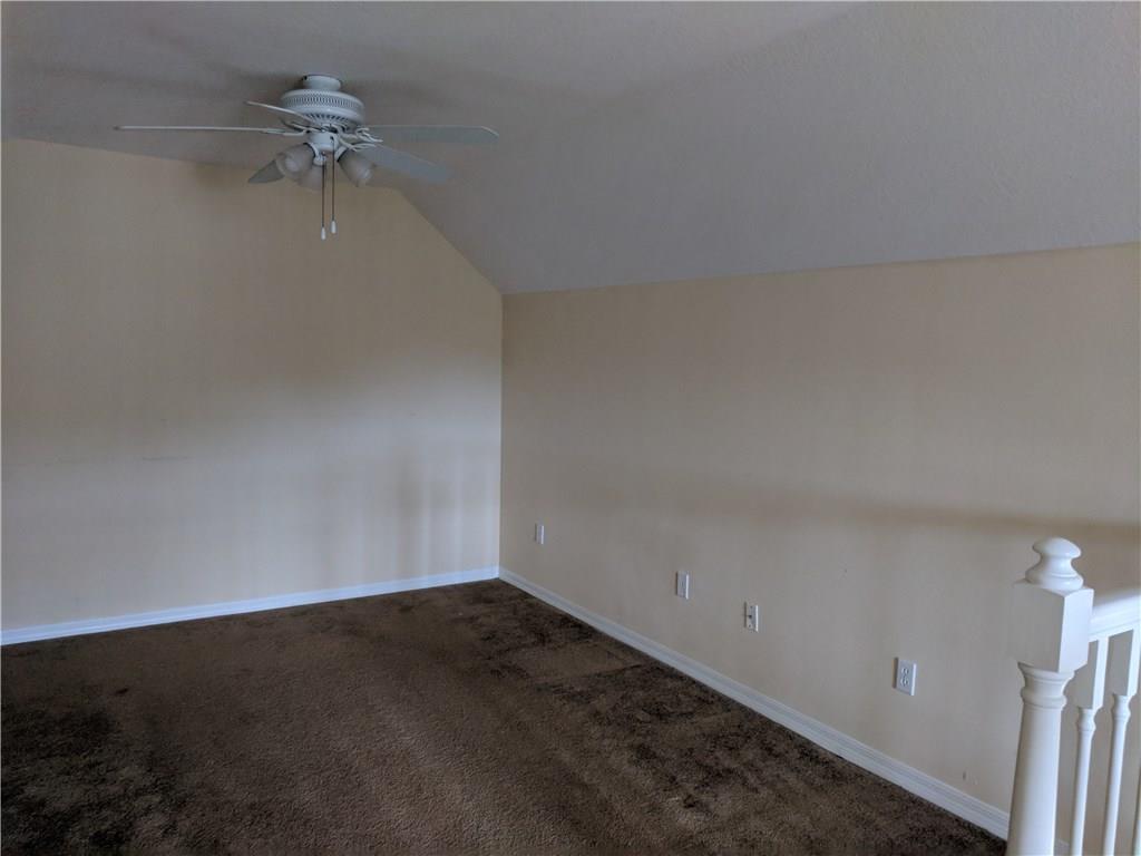 1645 Southeast Pomeroy Street, Unit 42 Stuart, FL 34997 - Photo 12 of 29 an empty room with a ceiling fan and a window