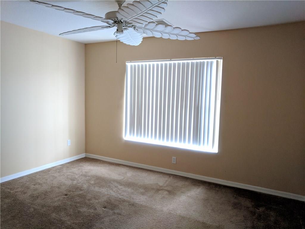 1645 Southeast Pomeroy Street, Unit 42 Stuart, FL 34997 - Photo 16 of 29 an empty room with windows