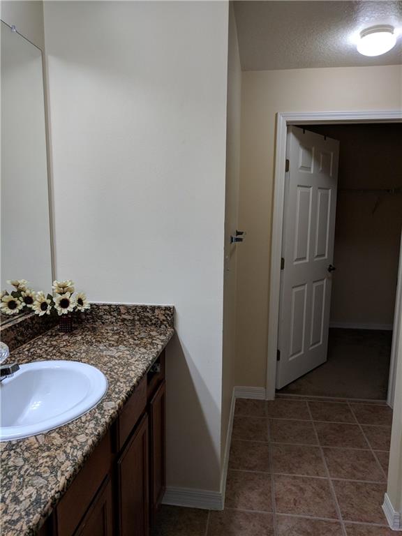 1645 Southeast Pomeroy Street, Unit 42 Stuart, FL 34997 - Photo 17 of 29 a bathroom with a granite countertop sink and a mirror