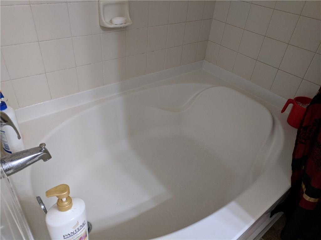 1645 Southeast Pomeroy Street, Unit 42 Stuart, FL 34997 - Photo 18 of 29 a bathroom with a bathtub