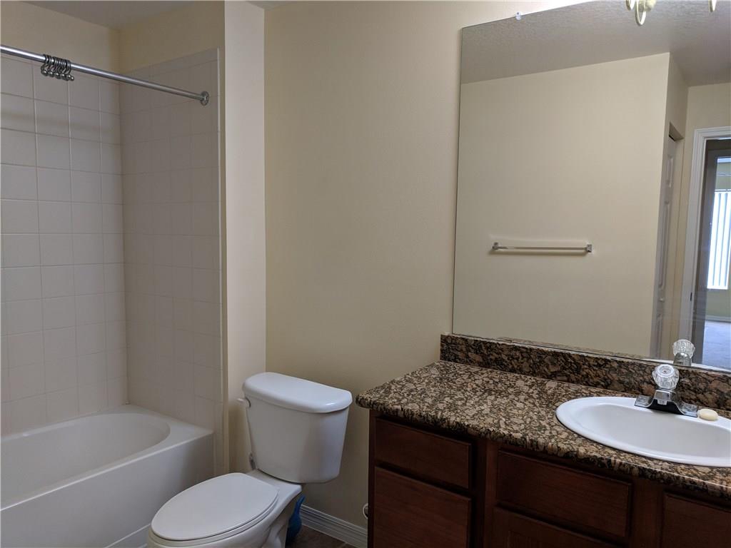 1645 Southeast Pomeroy Street, Unit 42 Stuart, FL 34997 - Photo 20 of 29 a bathroom with a granite countertop sink toilet and shower