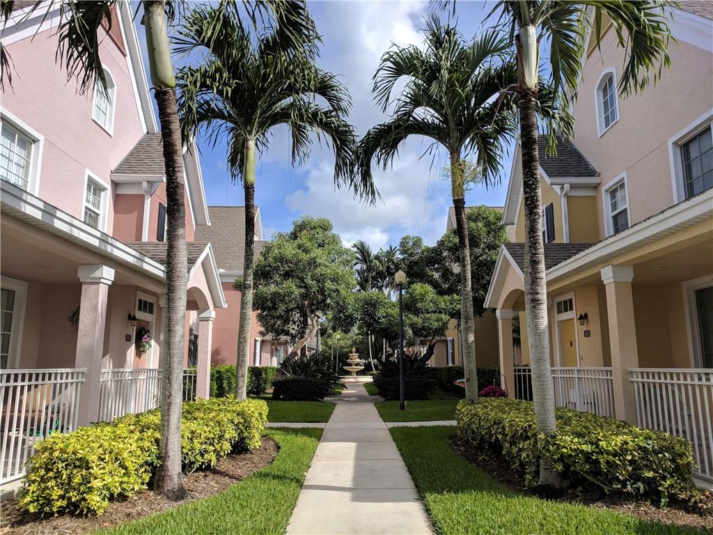 1645 Southeast Pomeroy Street, Unit 42 Stuart, FL 34997 - Photo 2 of 29 a front view of a house with a garden
