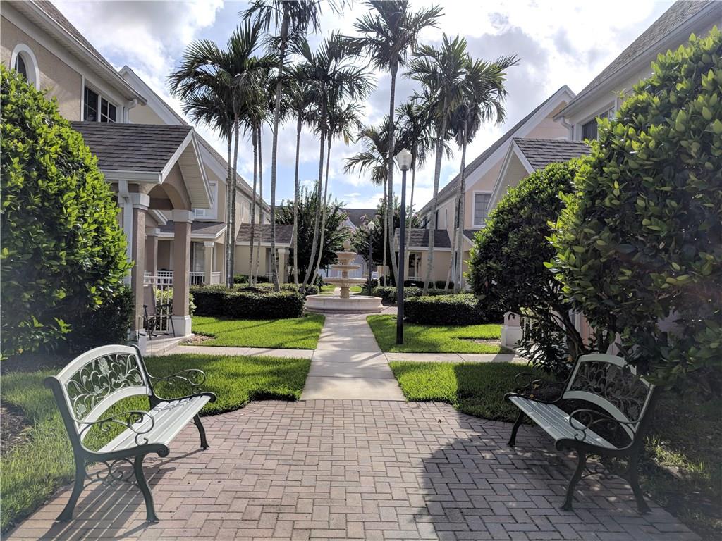 1645 Southeast Pomeroy Street, Unit 42 Stuart, FL 34997 - Photo 23 of 29 a view of house with swimming pool outdoor seating area and entertaining space