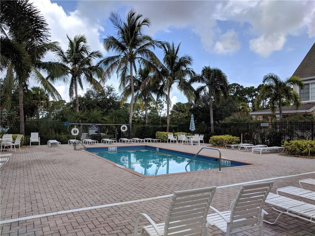 1645 Southeast Pomeroy Street, Unit 42 Stuart, FL 34997 - Photo 25 of 29 a view of swimming pool with outdoor seating and plants