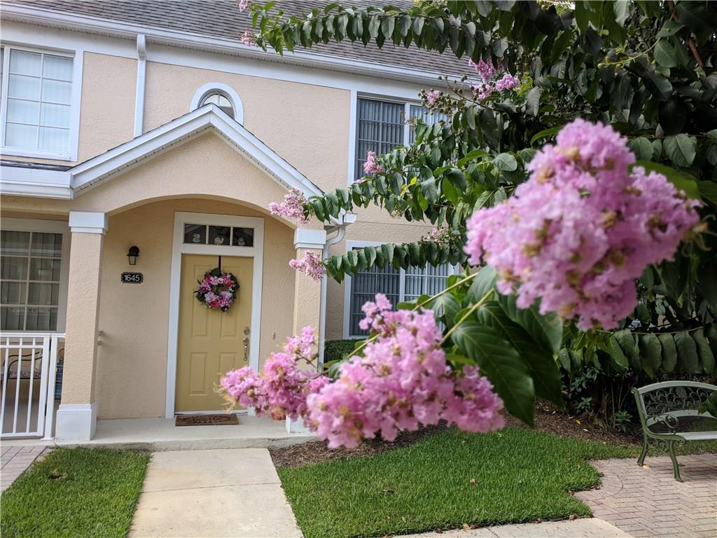1645 Southeast Pomeroy Street, Unit 42 Stuart, FL 34997 - Photo 3 of 29 a front view of small house with yard