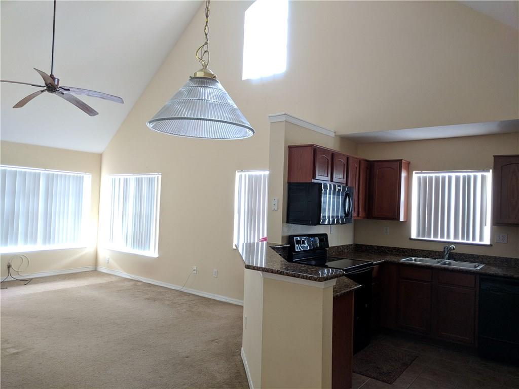1645 Southeast Pomeroy Street, Unit 42 Stuart, FL 34997 - Photo 6 of 29 a kitchen with a refrigerator and a stove top oven