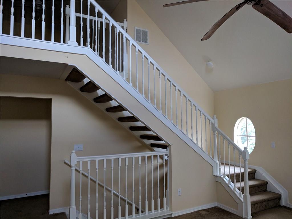 1645 Southeast Pomeroy Street, Unit 42 Stuart, FL 34997 - Photo 9 of 29 a view of staircase with wooden floor and white walls