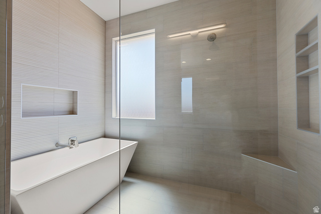 2955 East Rimrunner Drive St. George, UT 84790 - Photo 15 of 35 Freestanding soaking tub with a wall-mounted faucet, complemented by a tiled accent wall with an integrated niche